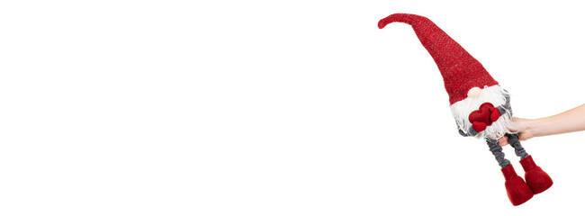 Hand with red christmas gnome isolated on white background.