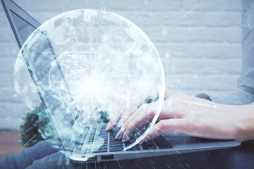 Double exposure of woman hands typing on computer and business theme hologram drawing. Success concept.