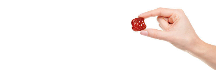 Hand with dried date isolated on white background.