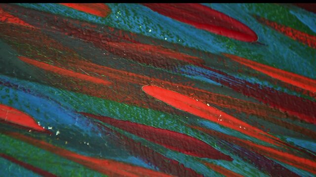 Many different colored lines painted bright paint on canvas close-up. Green, orange, red, blue colors. Brush strokes on canva. Cracks, scratches. Abstract grunge multicolored creativity art background