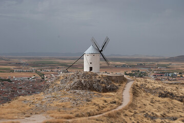 Old windmill in rural area and cloudy sky