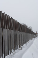 Road fence in winter landscape with snow
