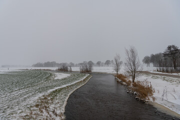 Creek in winter landscape with snow
