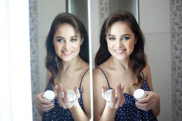 Young woman near the mirror skin care