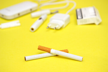 choosing between tobacco modern hybrid electronic cigarette device with heating system or classic cigarette. Health safety alternative, set cigarette vs nicotine