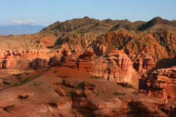 Charyn Canyon in South East Kazakhstan, summer 2019. Red rock canyon trail landscape. Trail in red rock canyon desert. Red rock canyon desert trail landscape. Yellow-red rocks of canyon in Kazakhstan.