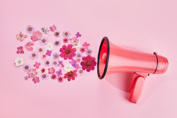 Pink megaphone with colorful flowers on pink background. Minimal nature concept. - obrazy, fototapety, plakaty