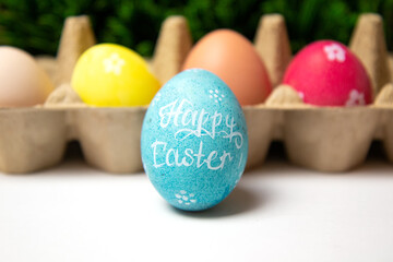 Close up of painted easter egg with Happy Easter wishes words