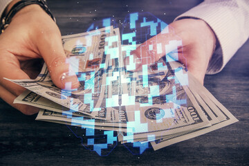 Multi exposure of technology drawing hologram and us dollars bills and man hands. Data concept