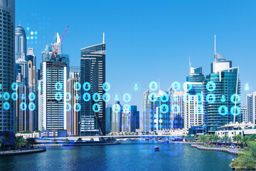 Skyscrapers of Dubai business downtown. International hub of trading and financial services. Social network icons hologram, concept of human resources. Double exposure. Dubai Canal waterfront.