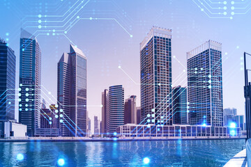 Skyscrapers of Dubai business downtown. International hub of trading and financial services. Technology theme icons hologram, Fintech concept. Double exposure. Dubai Canal waterfront.