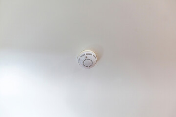 White indoor ceiling with fire alarm smoke catcher