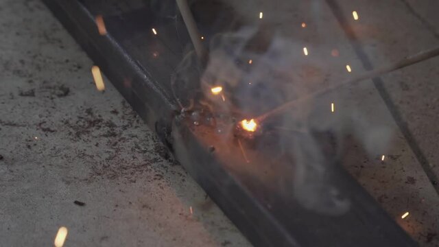 Close-up Metal Welder Working With Welding Machine With Bright Sparks And Flashes Weld Metal Construction. Footage B roll welding spark.