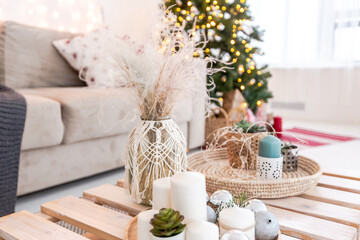 large very bright spacious stylish open plan Bali style apartment with hanging bed and panoramic windows. white floor and walls, simple wooden furniture. decorated with a christmas tree