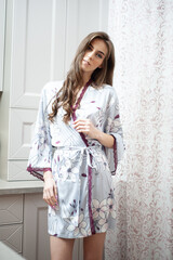 Fototapeta premium Morning beautiful young woman on the kitchen. Before breakfast