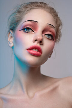 Closeup portrait of yong model with creative makeup and thin brows
