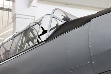 Close-up view of a vintage airplane in a hangar
