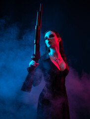 Vampire in black long corset dress in smoke holding a gun