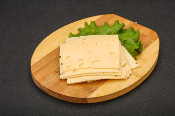 Sliced yellow cheese over board