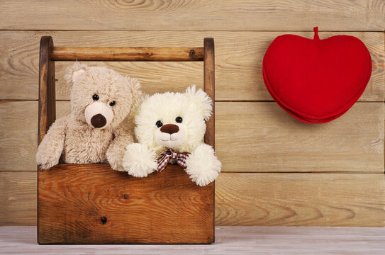 two teddy bears in the box with heart