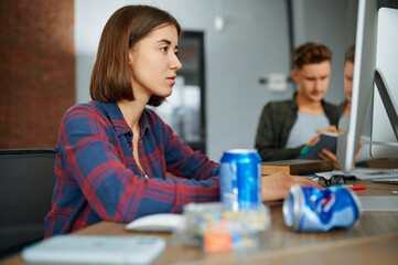 Focused IT specialist works on computer in office