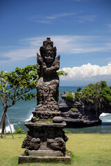 statue in a buddhist temple on blue sky with clouds and sea water background