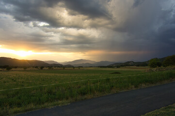beautiful sunset in a rural house with mountains behind, in the Aragonese Pyrenees, located in...