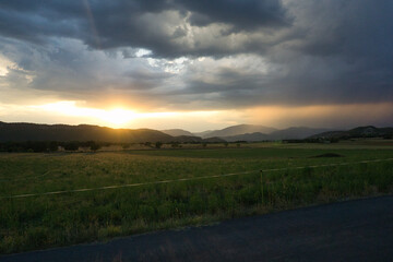 Fototapeta premium beautiful sunset in a rural house with mountains behind, in the Aragonese Pyrenees, located in Gerbe, Huesca, Spain