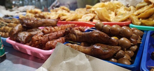 Dinner, on sidewalks sold on the roadside or angkringan "with a variety of satay and fried foods. Indonesian street food