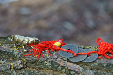 Tiger figurine and Chinese feng Shui coin close-up.