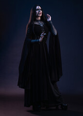 Young woman in black dress in Gothic style