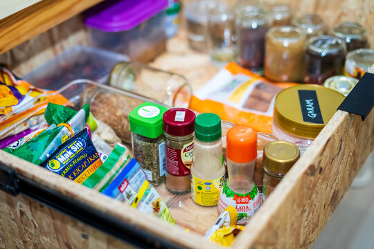 Kuala Lumpur, Malaysia - January 28, 2021: Top View Of Drawers With Spices Organized Inside. Modern Kitchen Countertop With Food Ingredients.