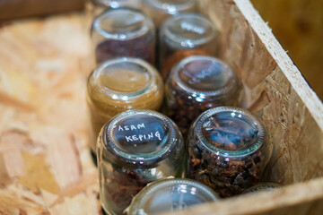 Top view of drawers with spices organized inside. Modern kitchen countertop with food ingredients.