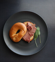 Bagel sandwich with corned beef and sage leaves