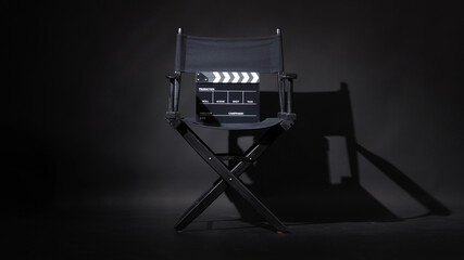 Black director chair and Clapper board or movie Clapperboard on black background.use in video...