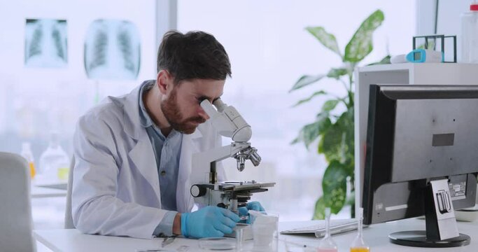 Young microbiologist doctor scientist working in medical laboratory researching new vaccination against influenza. Caucasian physician. Medical Science.
