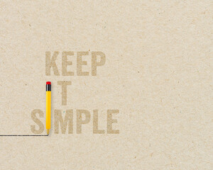KISS Concept - Keep it simple and stupid with yellow pencils on brown paper and chalkboard background