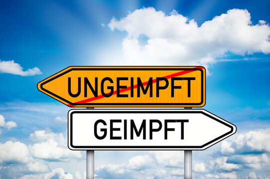 Road sign with the german words for covid-19 vaccination vaccinated and unvaccinated - geimpft und ungeimpft with blue sky background