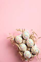 Creative layout with colorful easter eggs on pink background. Happy Easter vertical banner mockup.