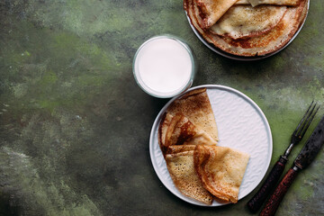 Thin pancakes with milk in a plate. crepes 