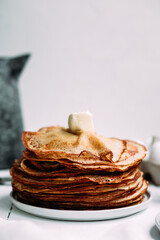 Thin pancakes with milk in a plate. crepes 