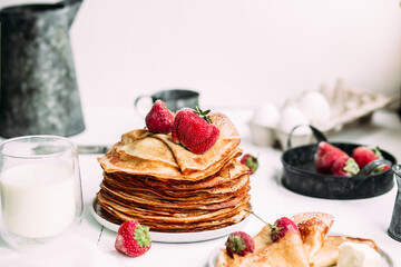 Thin pancakes with milk in a plate. crepes 