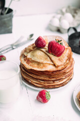 Thin pancakes with milk in a plate. crepes 