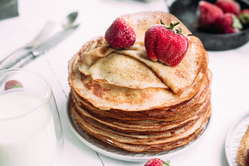 Thin pancakes with milk in a plate. crepes 
