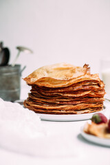 Thin pancakes with milk in a plate. crepes 