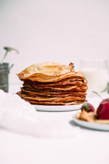 Thin pancakes with milk in a plate. crepes 