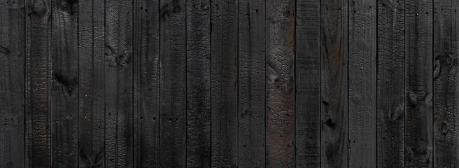 Black wood texture background coming from natural tree. The wooden panel has a beautiful dark...