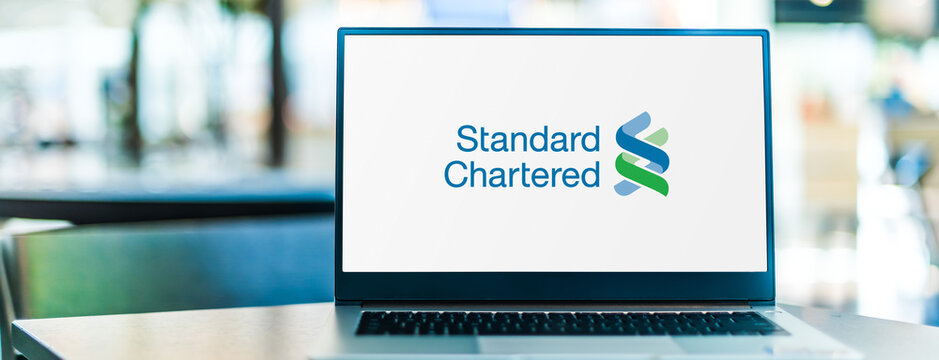 Laptop computer displaying logo of Standard Chartered