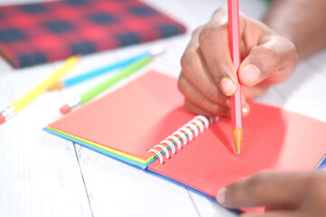 Close up of man hand writing on notepad.