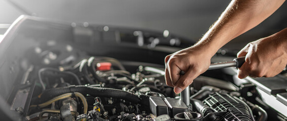 Fototapeta Auto mechanic working and repair on car engine in mechanics garage. Car service. obraz